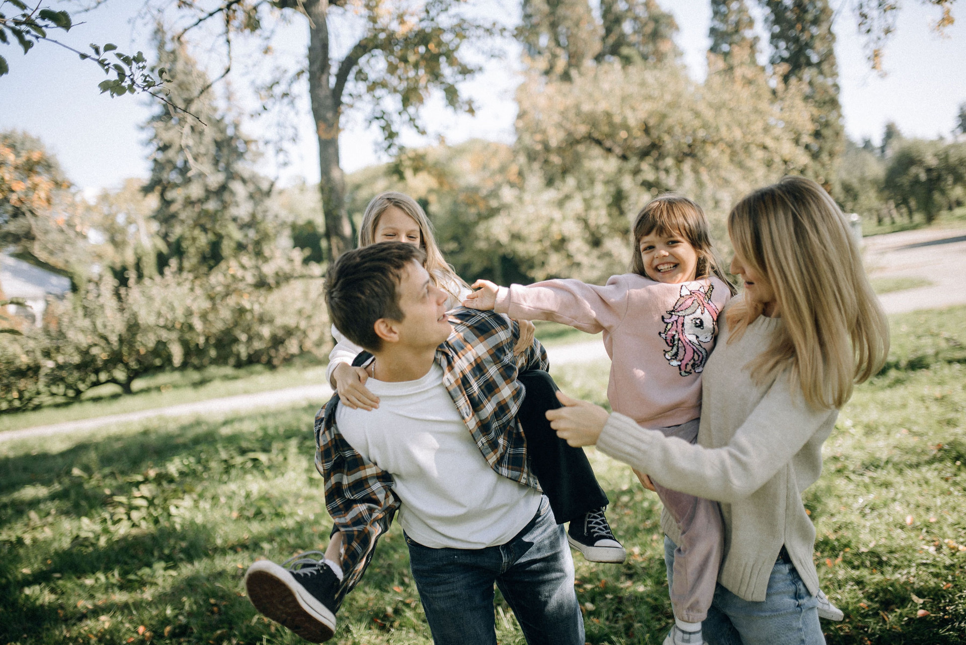 A family playing together in a park on a sunny afternoon